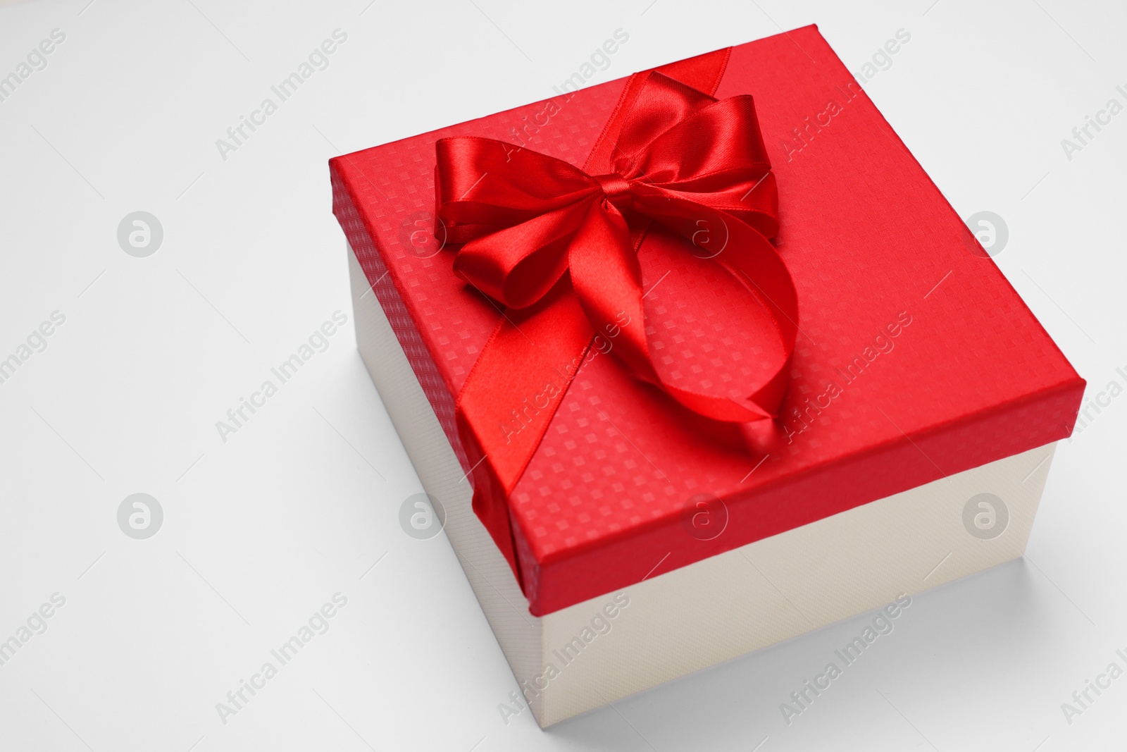 Photo of Gift box with bow on light grey background