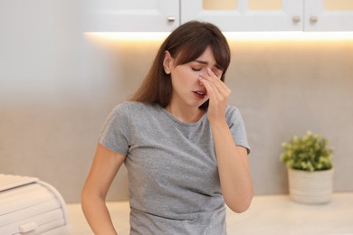 Photo of Tired woman suffering from sinusitis at home