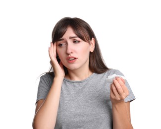 Woman with napkin suffering from sinusitis on white background