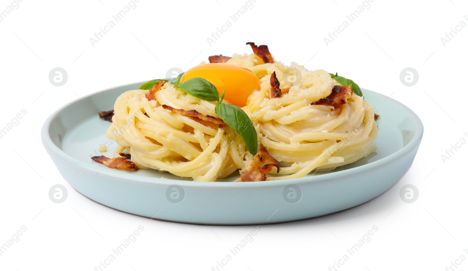 Photo of Delicious pasta Carbonara with egg yolk, bacon and basil isolated on white