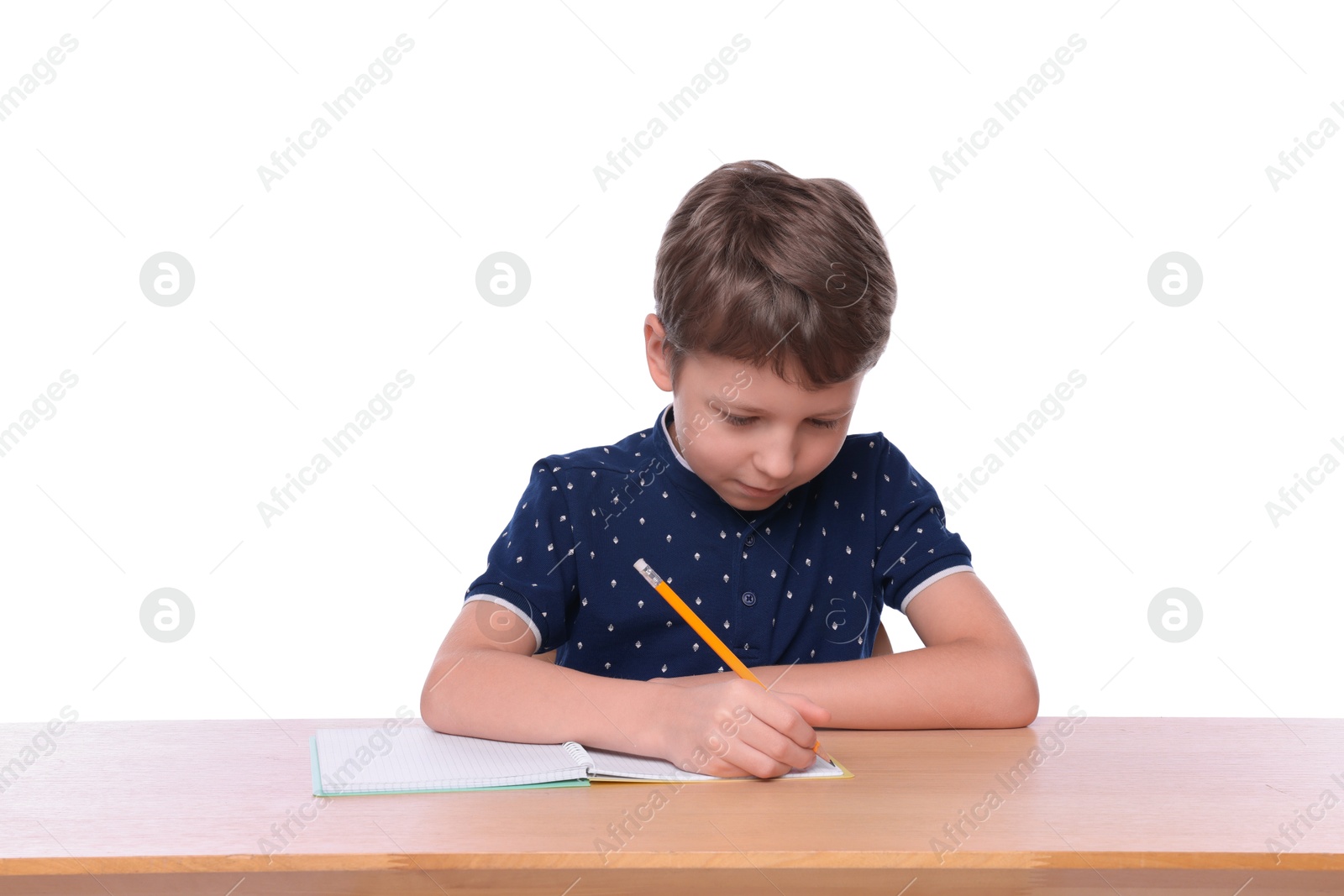 Photo of Boy with incorrect posture and notebook at wooden desk on white background