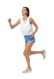 Beautiful young woman running on white background