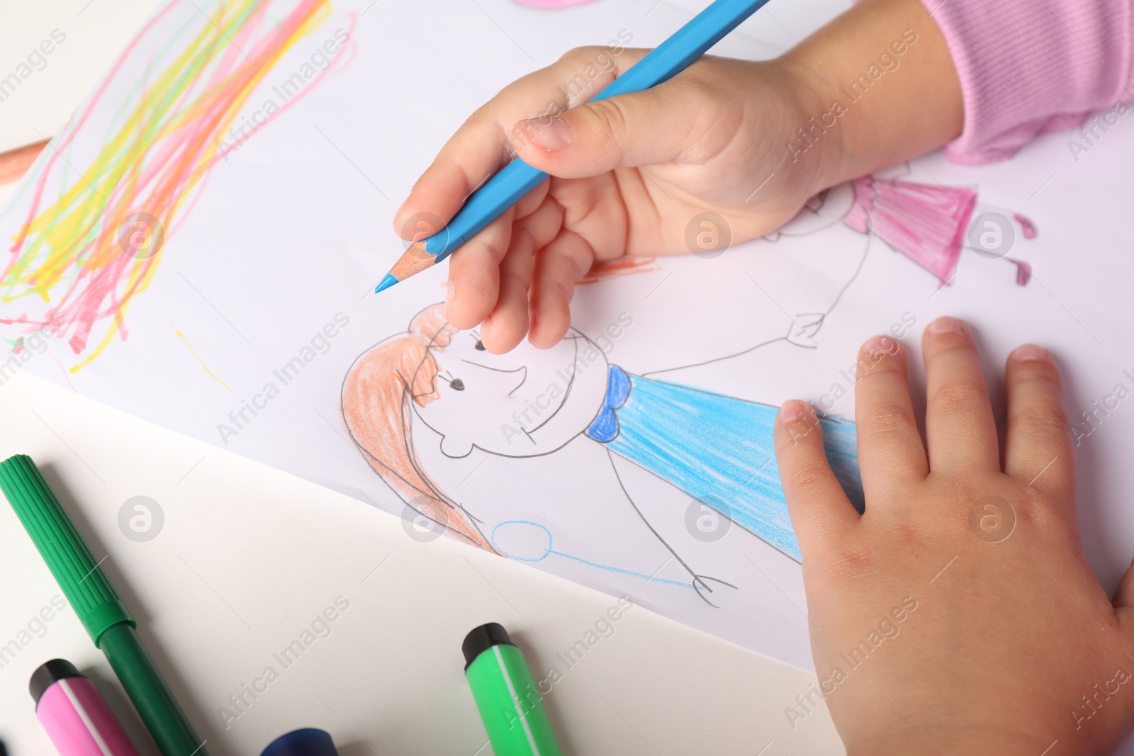 Photo of Little girl drawing his family at white table, closeup