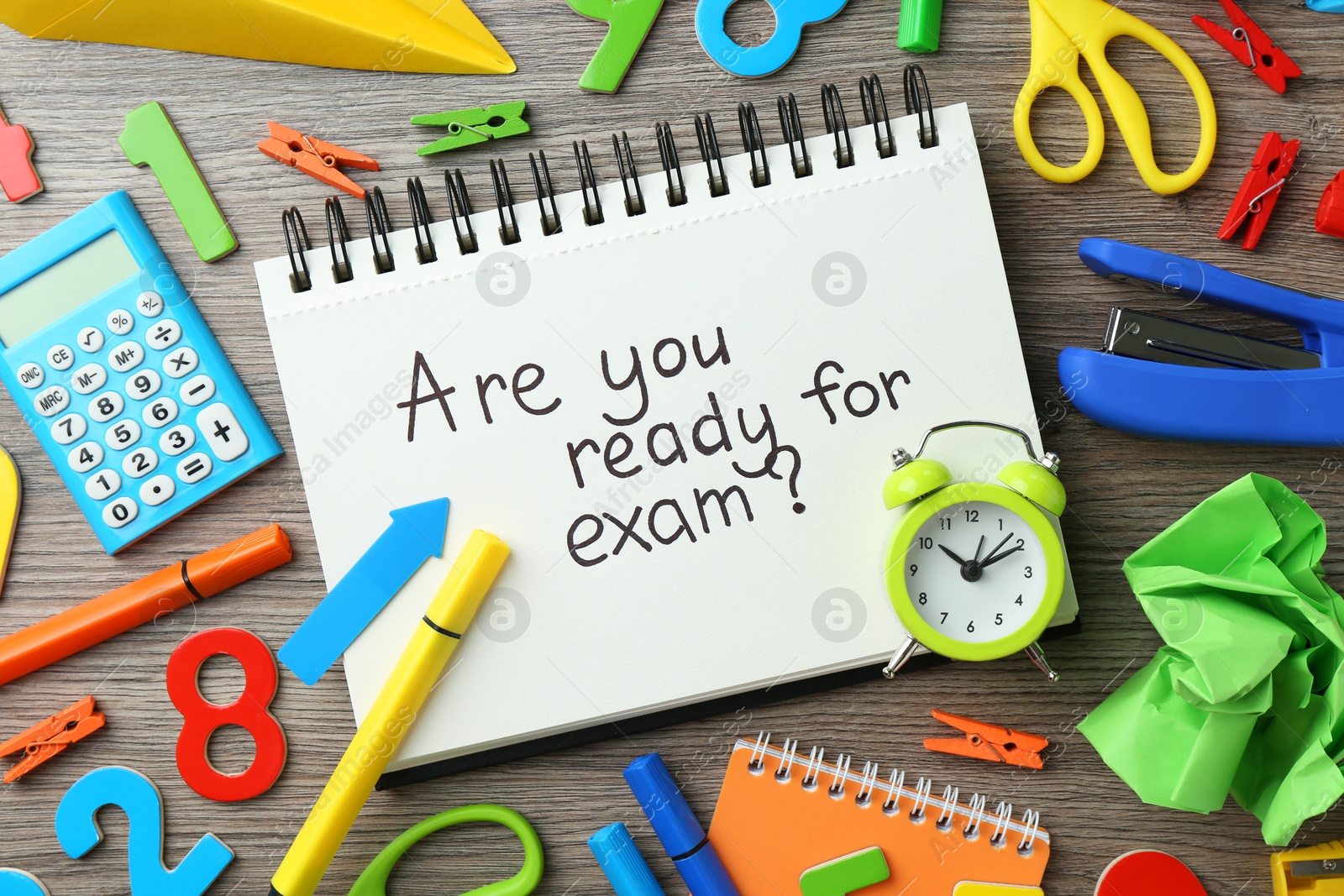 Photo of Notepad with question Are You Ready For Exam and stationery on wooden desk, flat lay