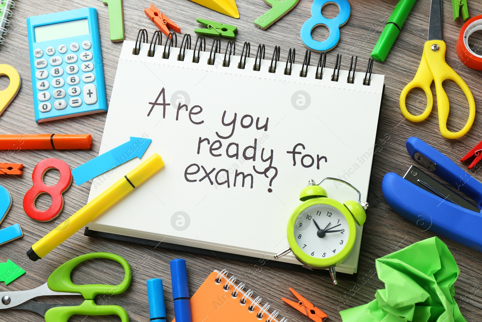 Photo of Notepad with question Are You Ready For Exam and stationery on wooden desk, closeup