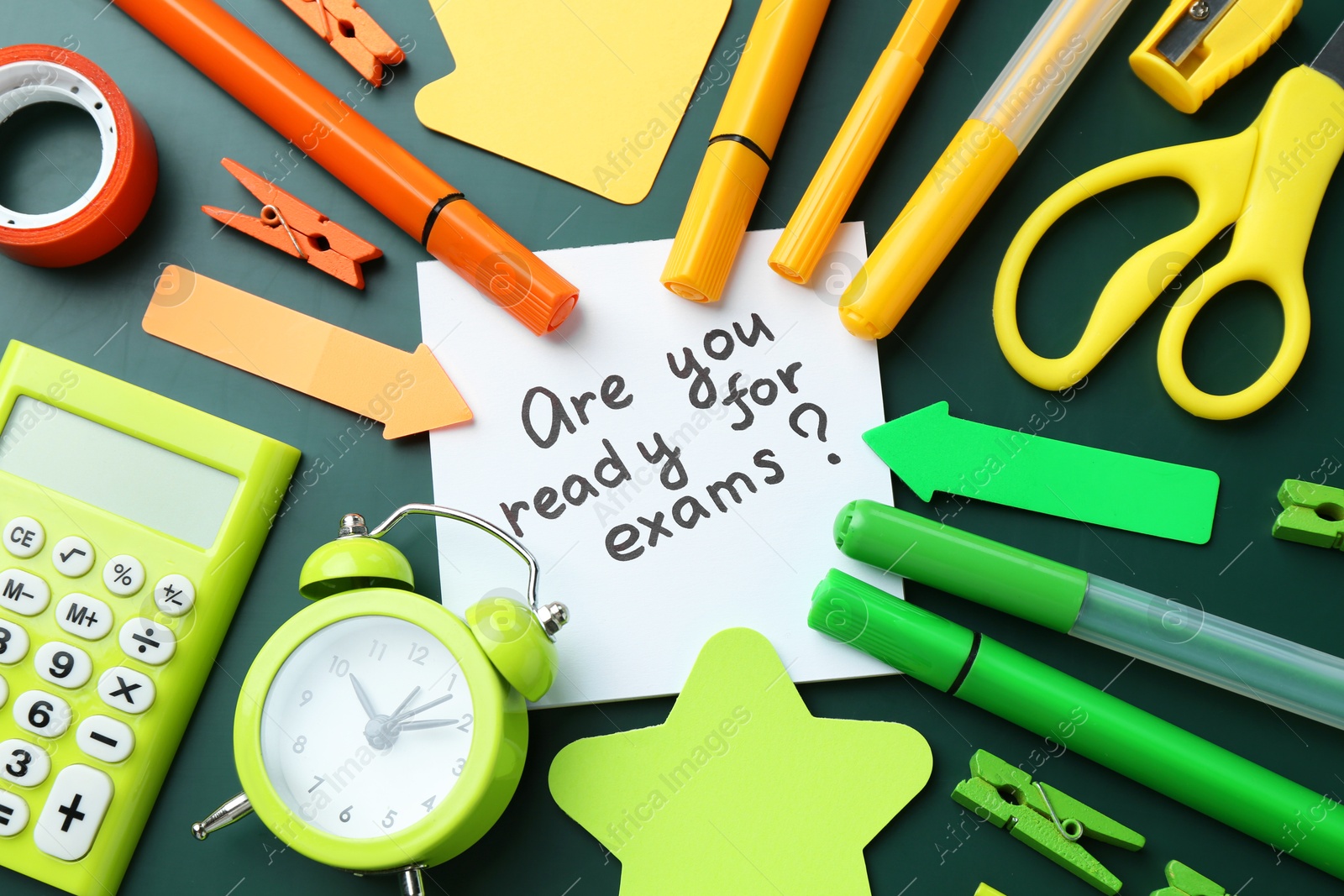 Photo of Note with question Are You Ready For Exams and stationery on green background, flat lay