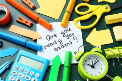 Note with question Are You Ready For Exams and stationery on green background, closeup