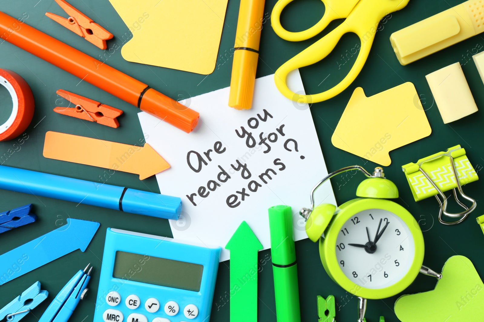 Photo of Note with question Are You Ready For Exams and stationery on green background, flat lay