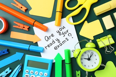 Note with question Are You Ready For Exams and stationery on green background, flat lay