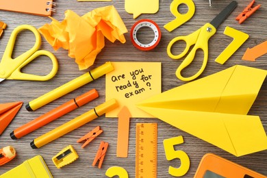 Note with question Are You Ready For Exam and stationery on wooden desk, flat lay