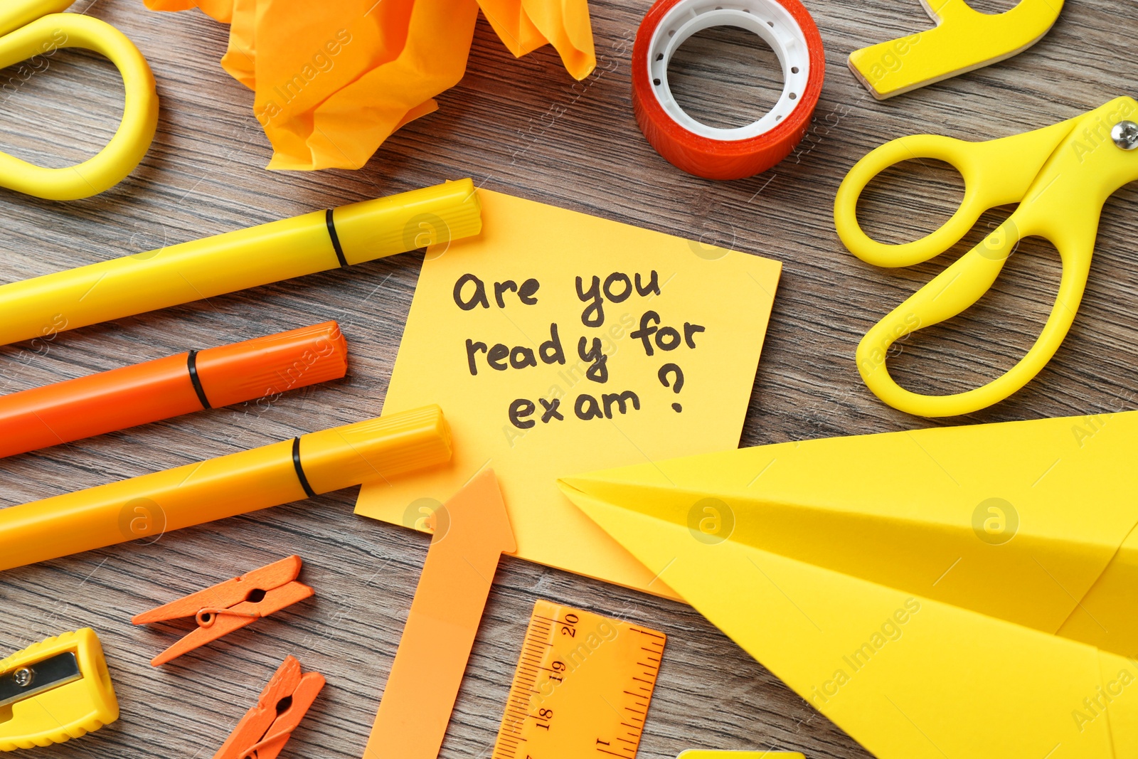 Photo of Note with question Are You Ready For Exam and stationery on wooden desk, flat lay