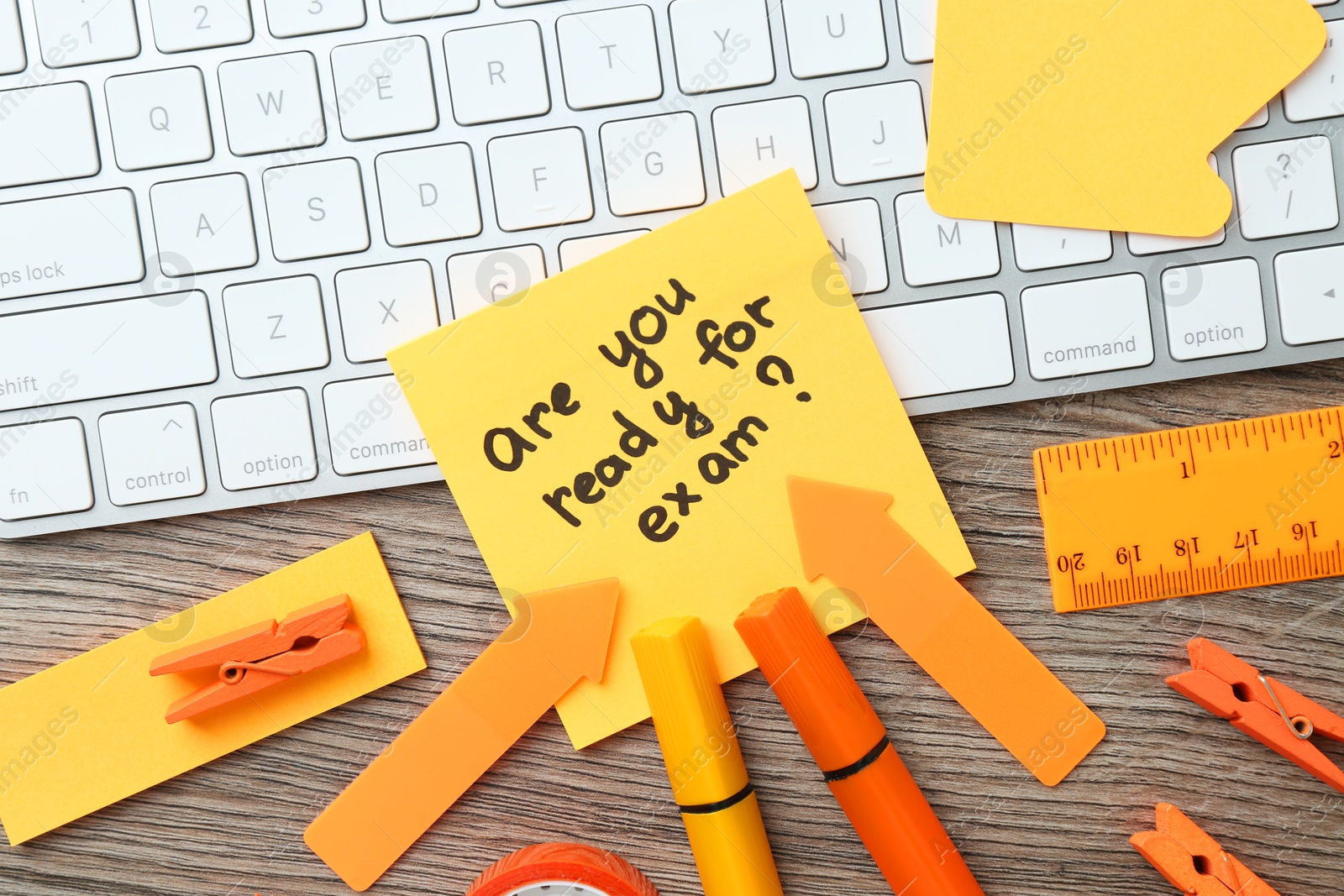 Photo of Note with question Are You Ready For Exam and stationery on wooden desk, flat lay