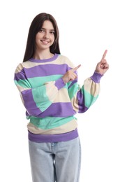 Portrait of cute teenage girl pointing at something on white background