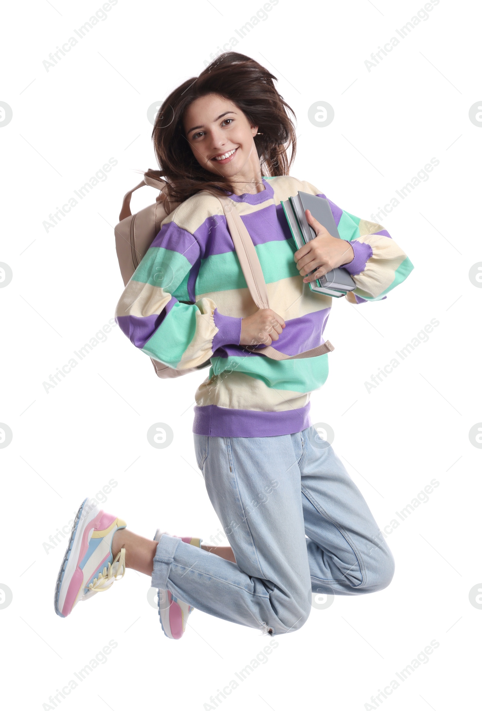 Photo of Teenage girl with backpack jumping on white background