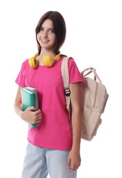 Portrait of smiling teenage girl with backpack and books on white background