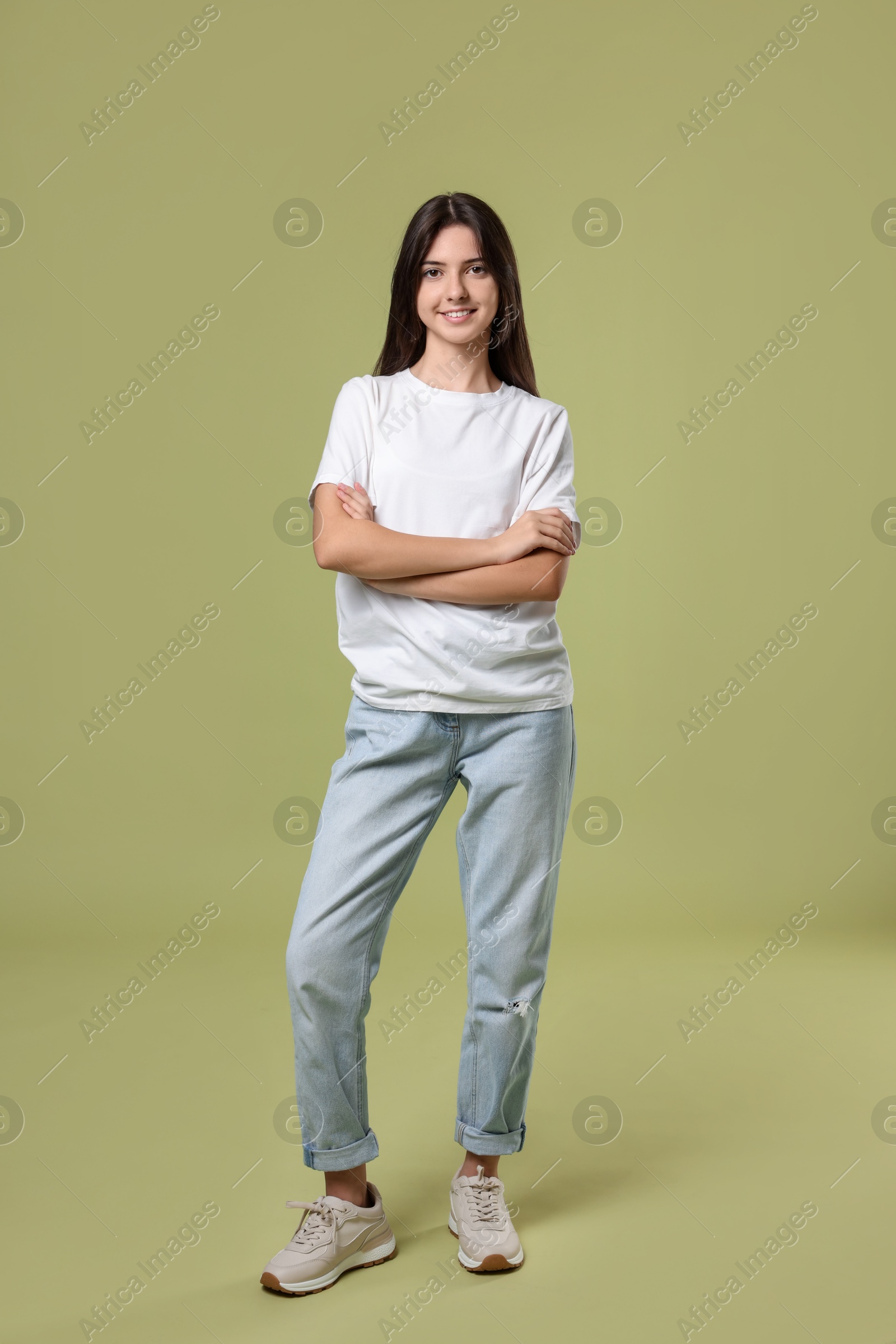 Photo of Full length portrait of cute teenage girl on olive background