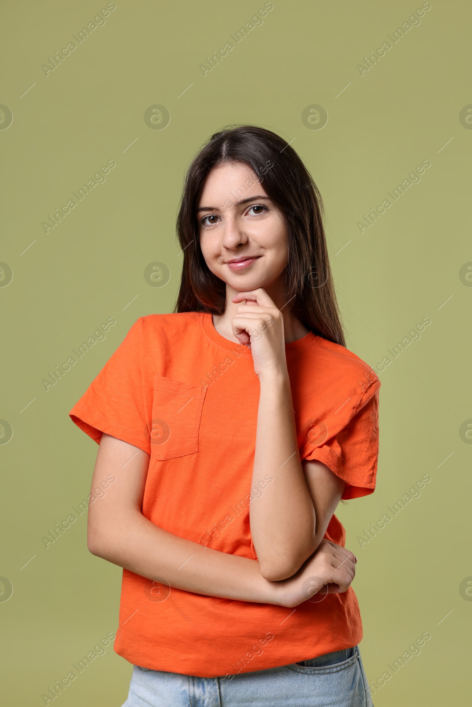 Photo of Portrait of cute teenage girl on olive background