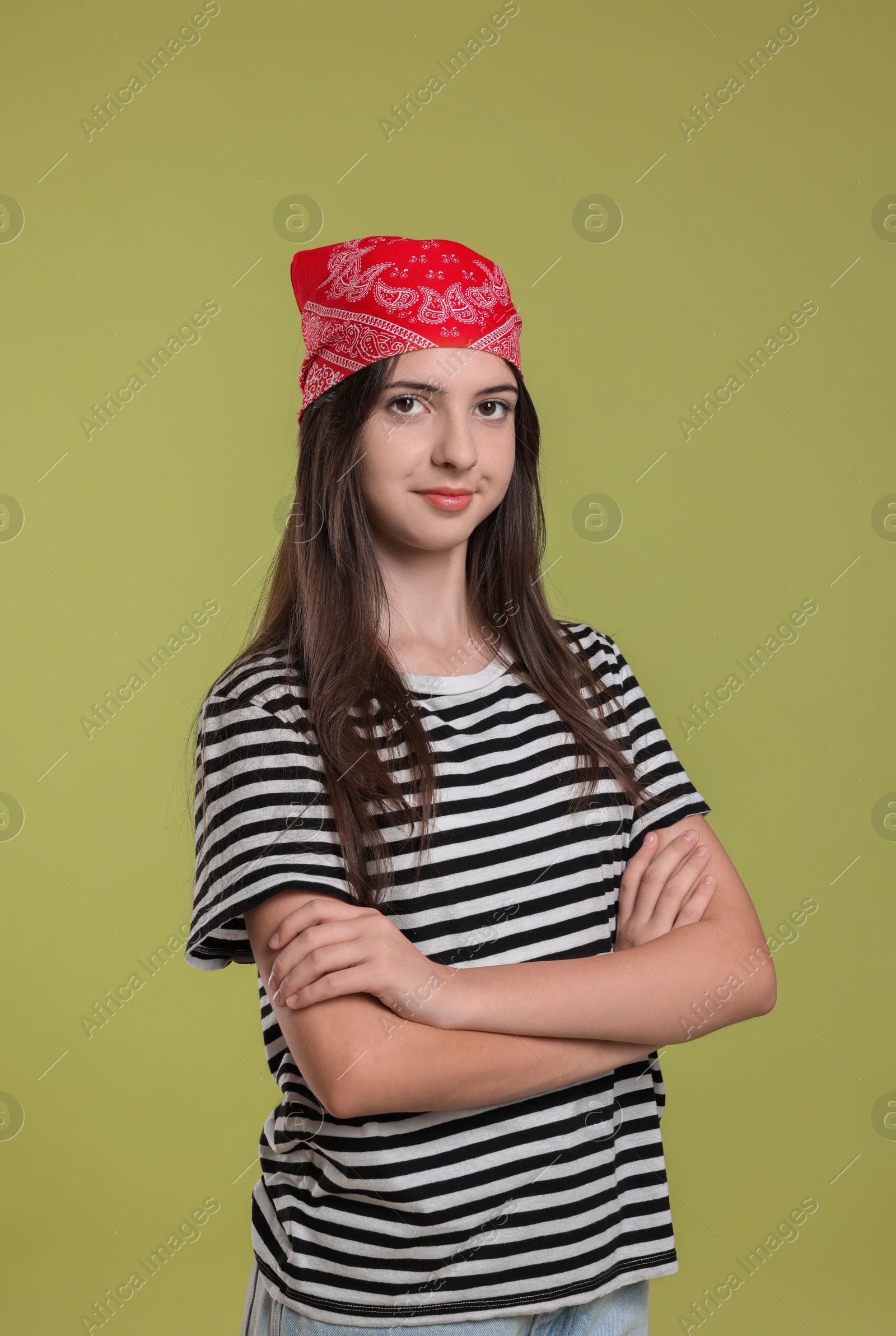 Photo of Portrait of cheerful teenage girl jumping on olive background