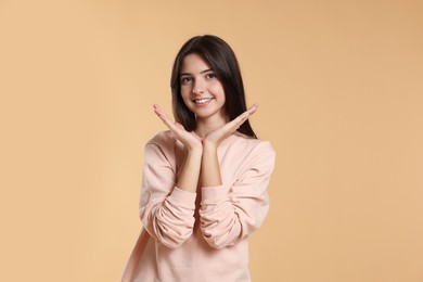 Photo of Portrait of cute teenage girl on beige background