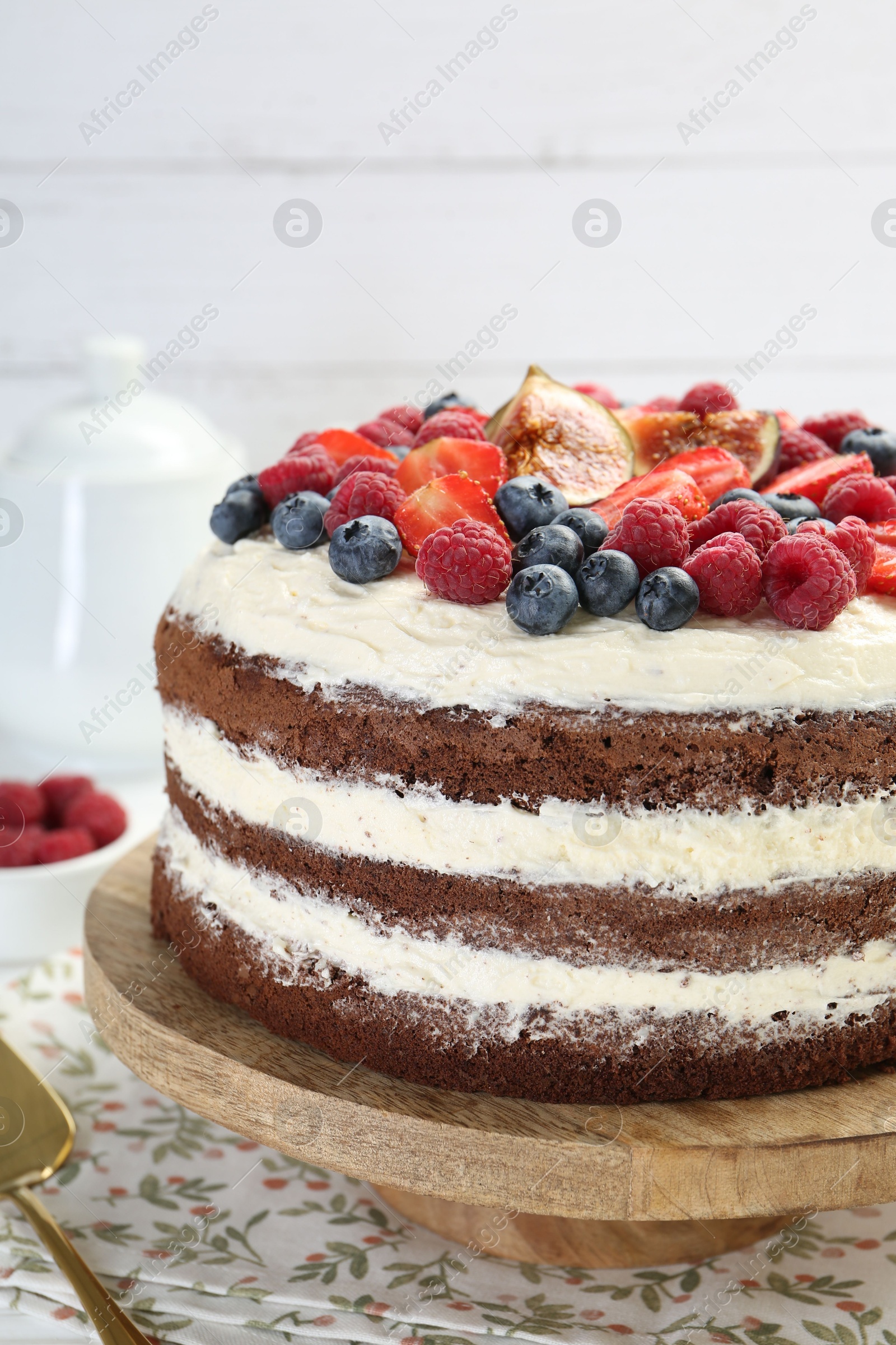 Photo of Delicious chocolate sponge cake with berries on table, closeup