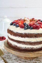 Photo of Delicious chocolate sponge cake with berries on table, closeup