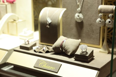 Photo of Store display with different jewelry in shopping mall, selective focus