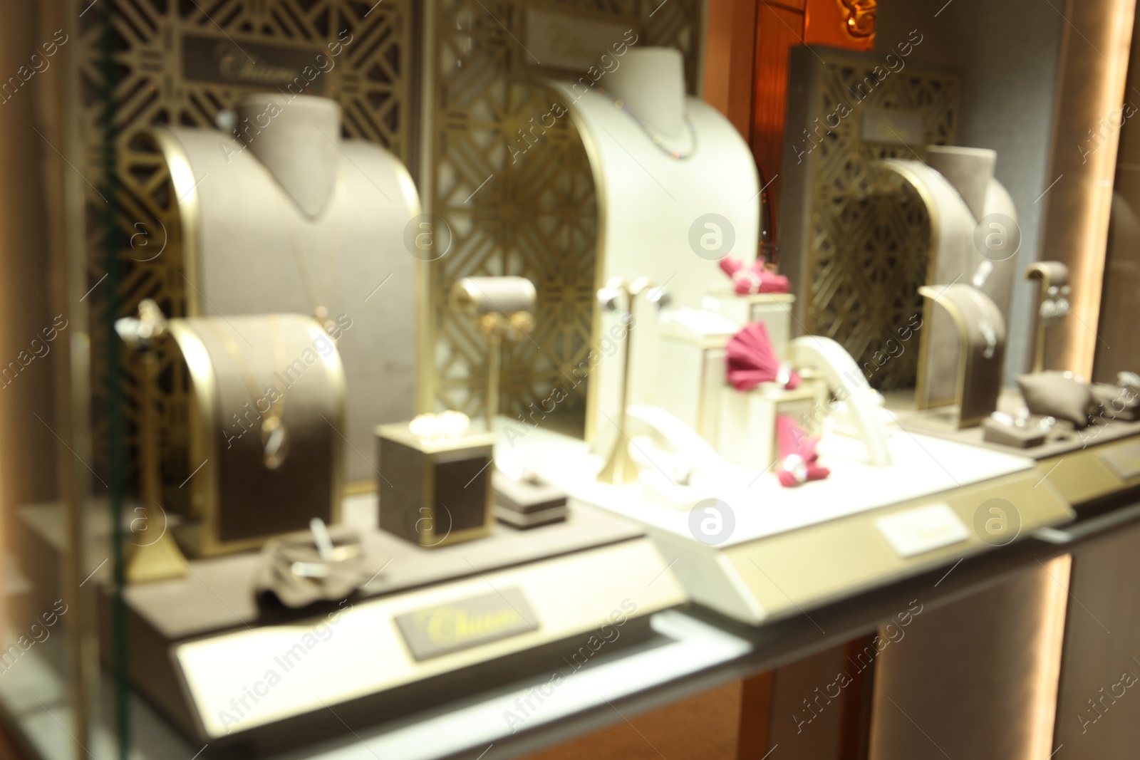 Photo of Blurred view of store display with different jewelry in shopping mall