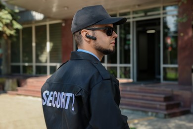 Security guard in uniform and sunglasses outdoors