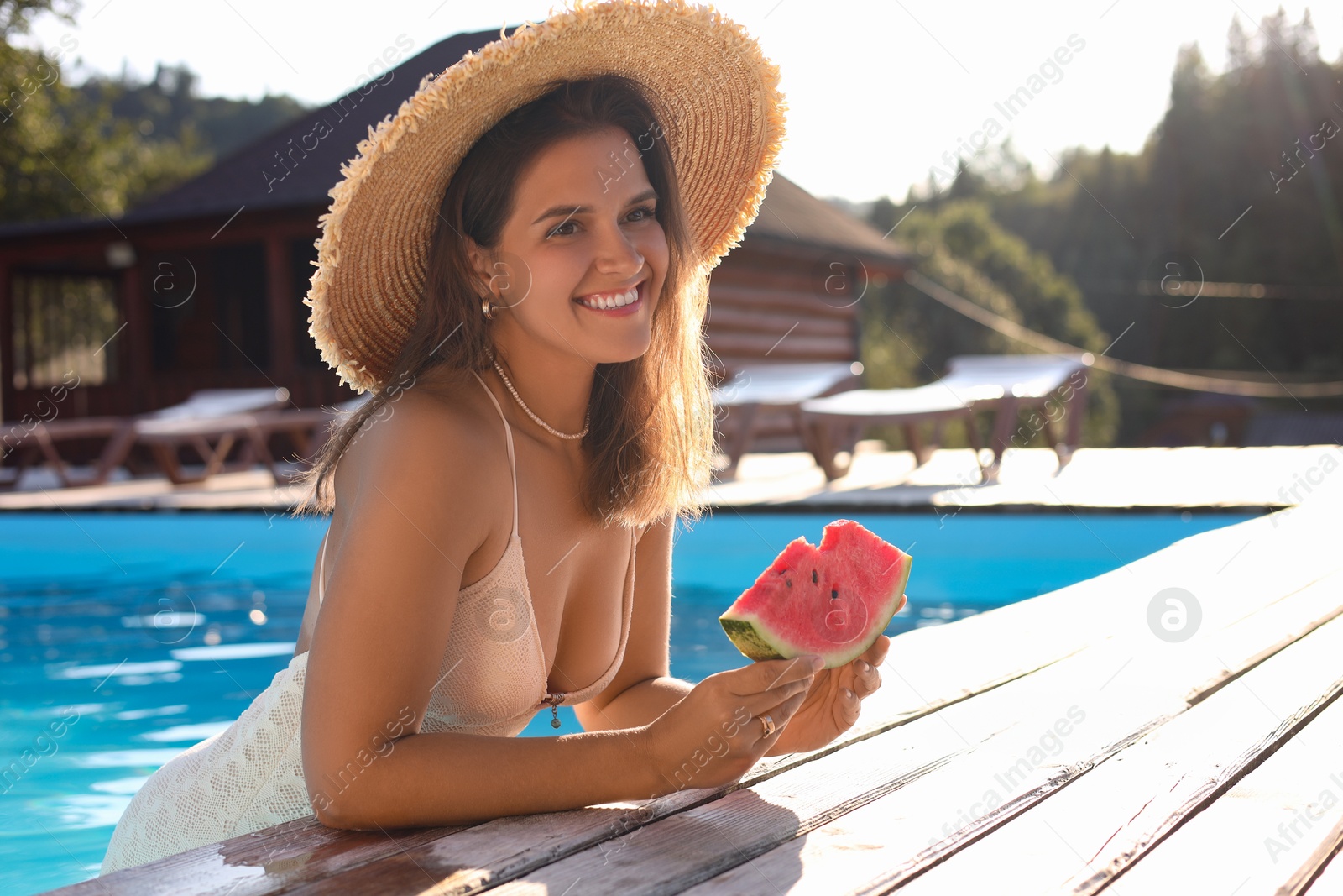 Photo of Happy woman with slice of juicy watermelon in swimming pool outdoors, space for text