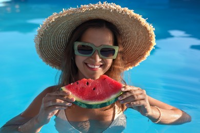 Photo of Happy woman with slice of juicy watermelon in swimming pool outdoors