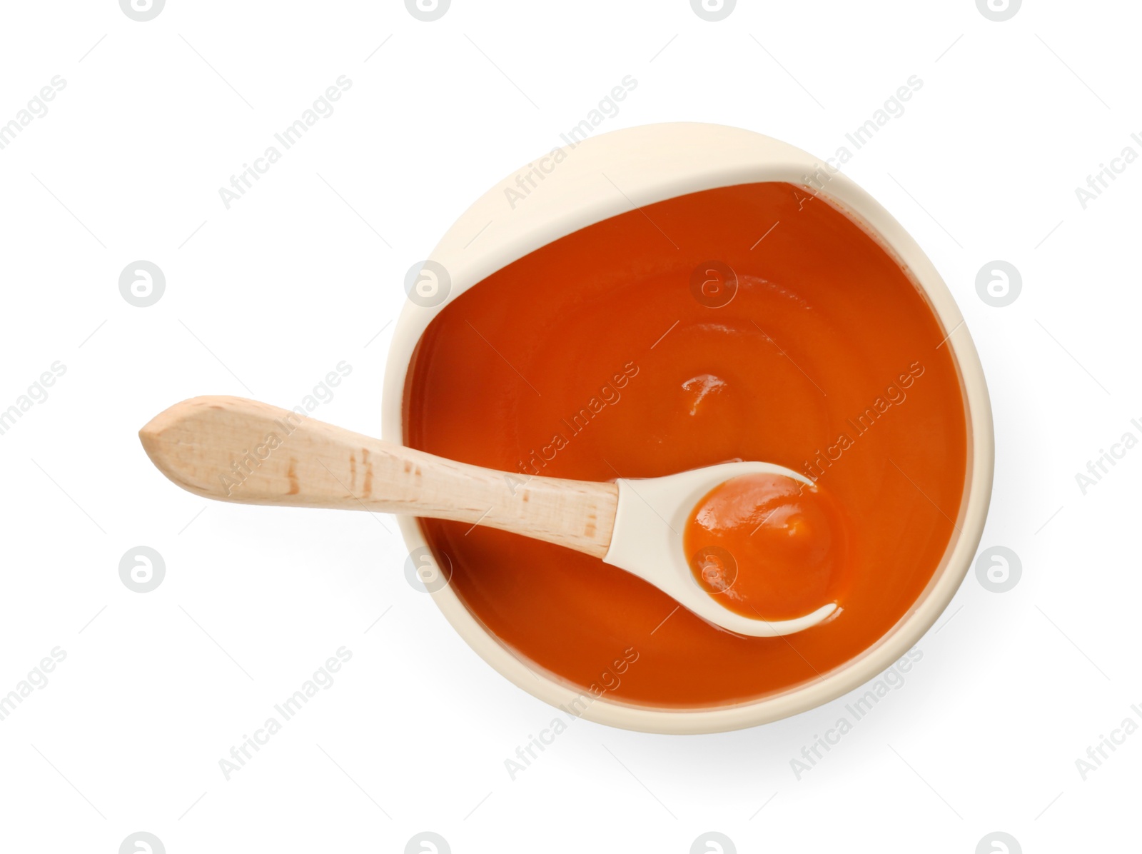 Photo of Delicious baby food in bowl and spoon isolated on white, top view