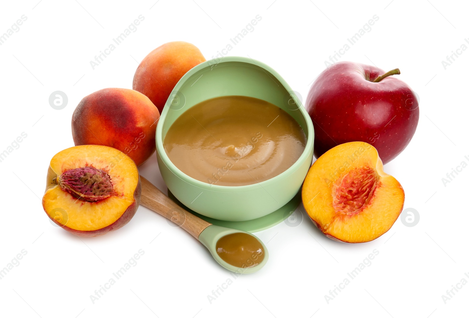 Photo of Delicious baby food in bowl with spoon and fresh ingredients isolated on white