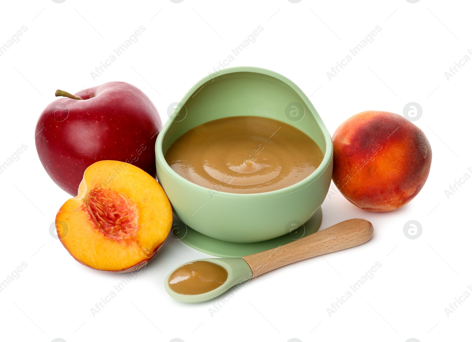 Photo of Delicious baby food in bowl with spoon and fresh ingredients isolated on white