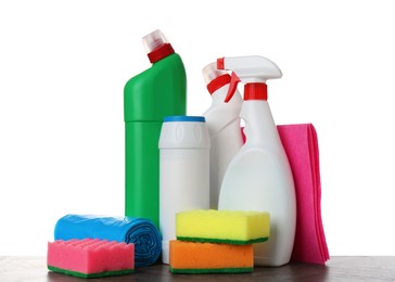 Photo of Different toilet cleaners, sponges, rag and trash bags on wooden table against white background