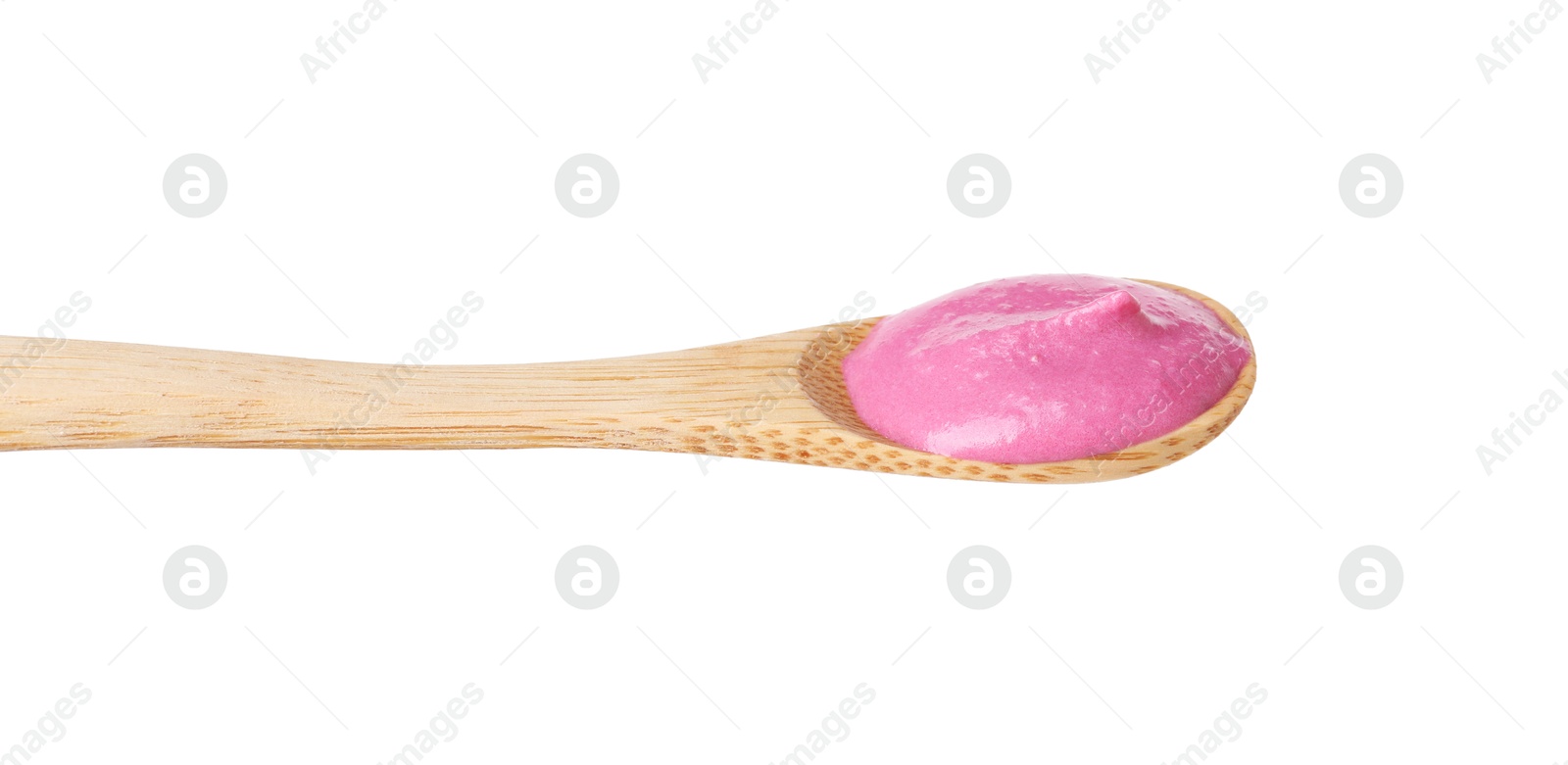 Photo of Tasty beetroot hummus in wooden spoon isolated on white