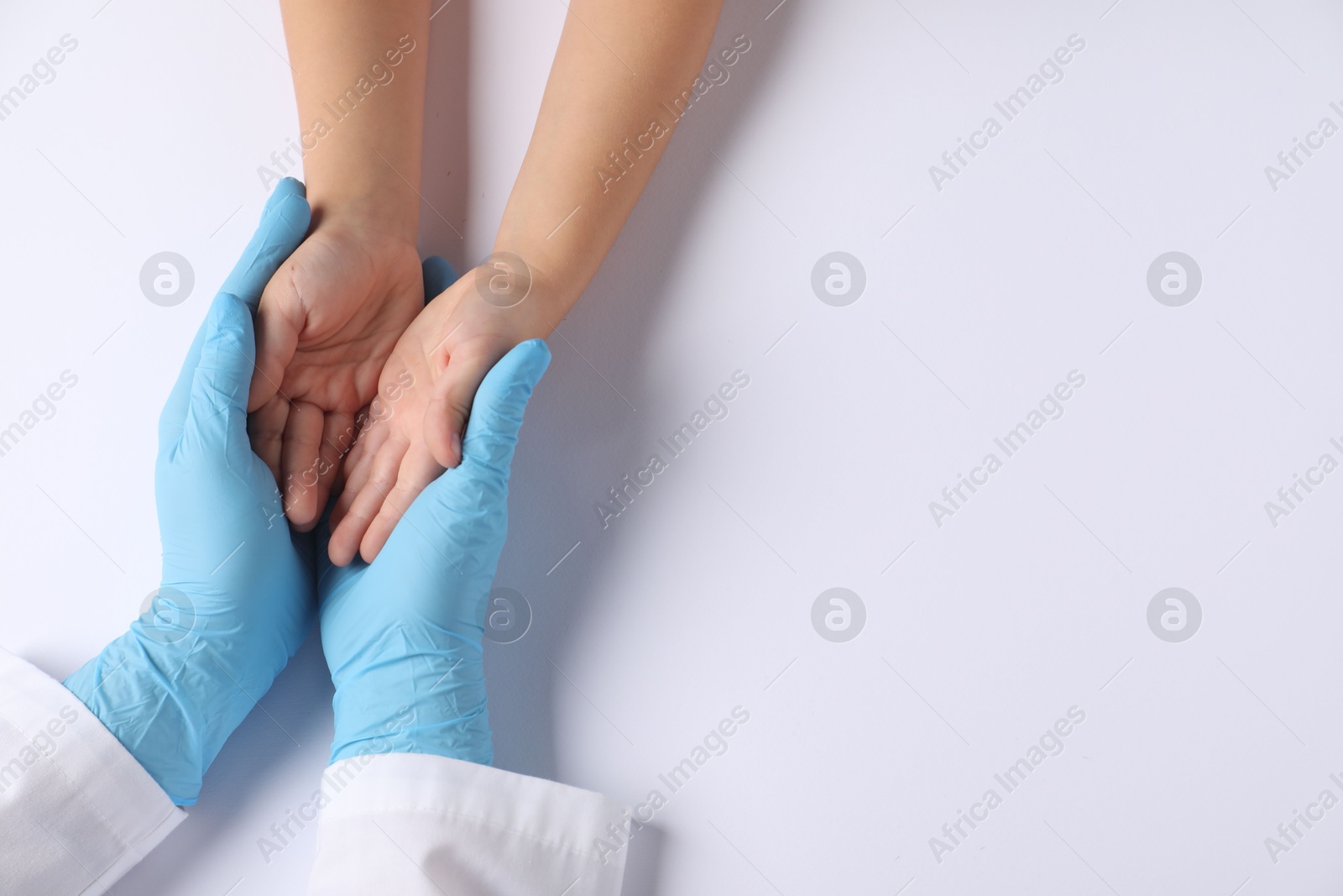 Photo of Doctor and child on white background, top view. Space for text