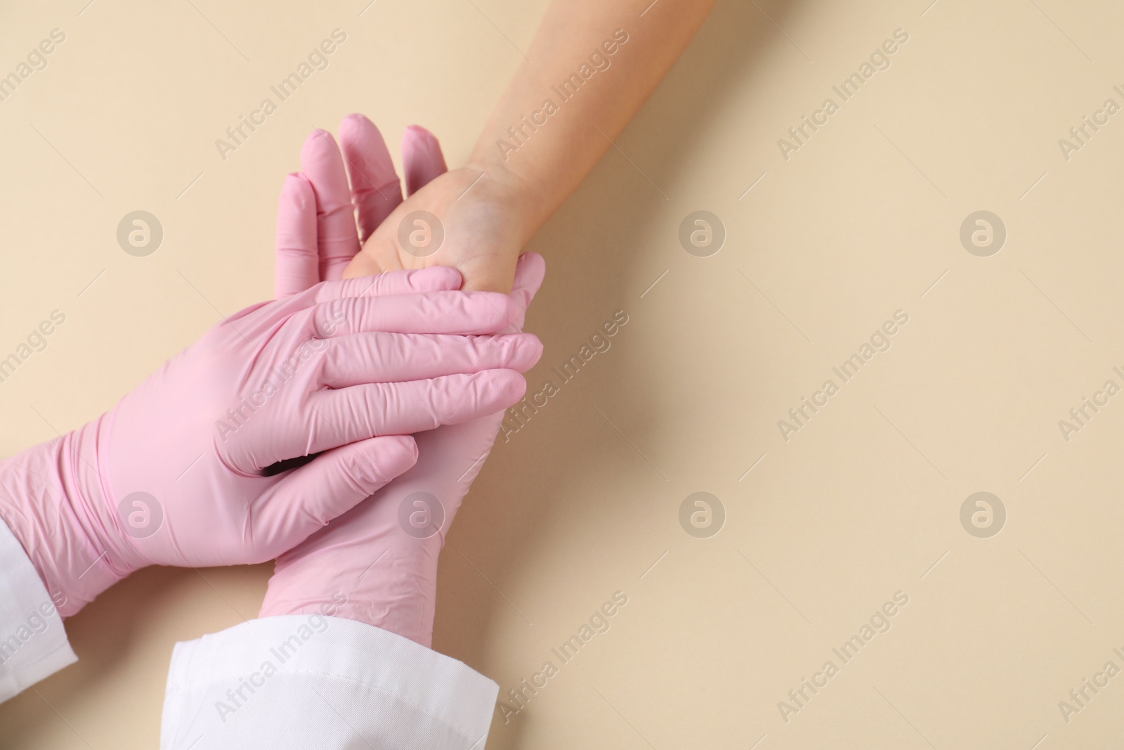 Photo of Doctor and child on beige background, top view. Space for text