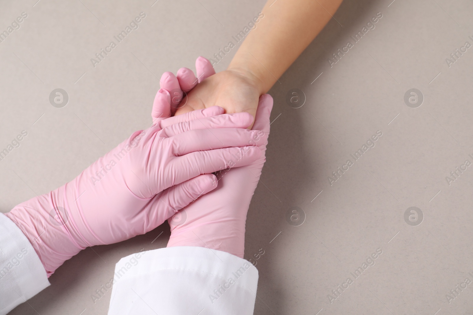 Photo of Doctor and child on light grey background, above view