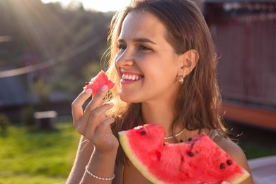 Photo of Woman eating fresh juicy watermelon outdoors on sunny day