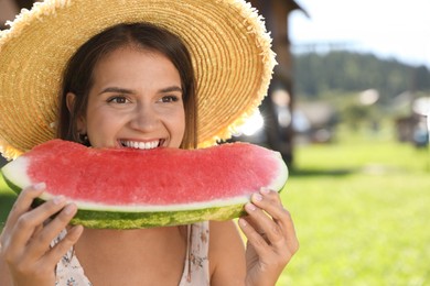 Happy woman eating fresh juicy watermelon outdoors