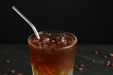 Photo of Refreshing espresso tonic drink on dark background, closeup