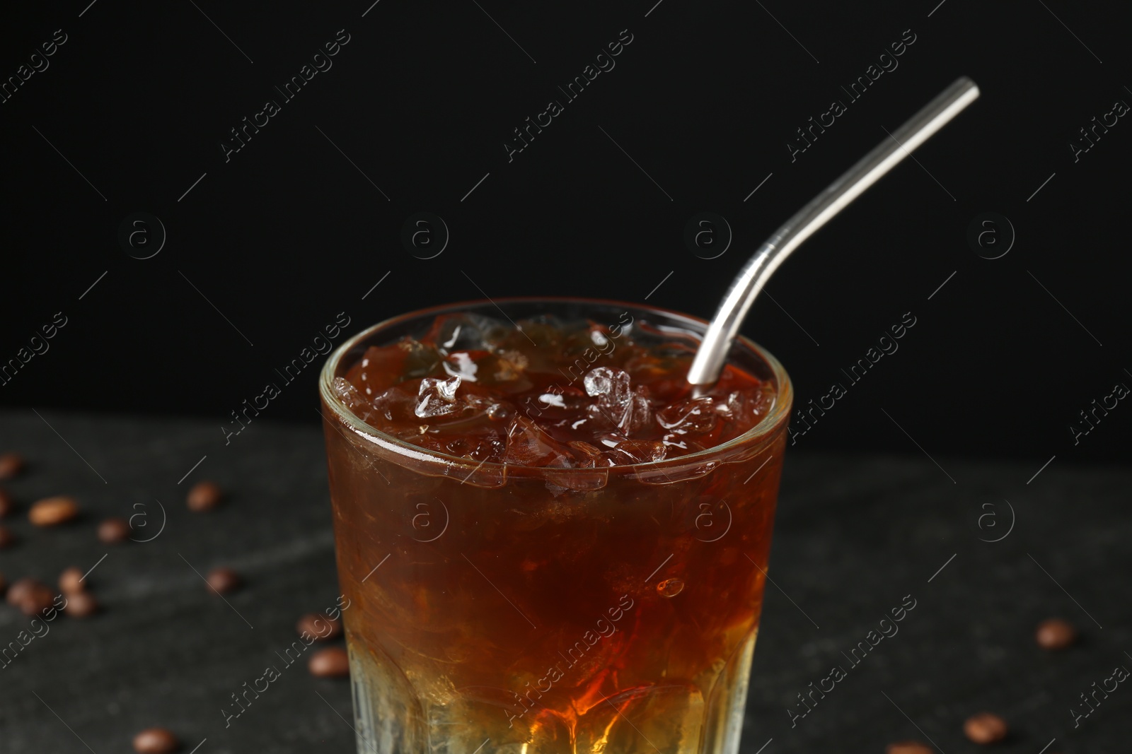 Photo of Refreshing espresso tonic drink on dark background, closeup