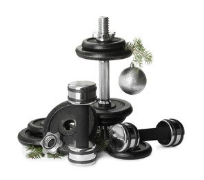 Photo of Dumbbells and Christmas decor isolated on white