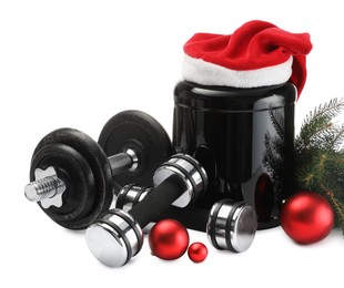 Photo of Dumbbells, container with supplement and Christmas decor isolated on white