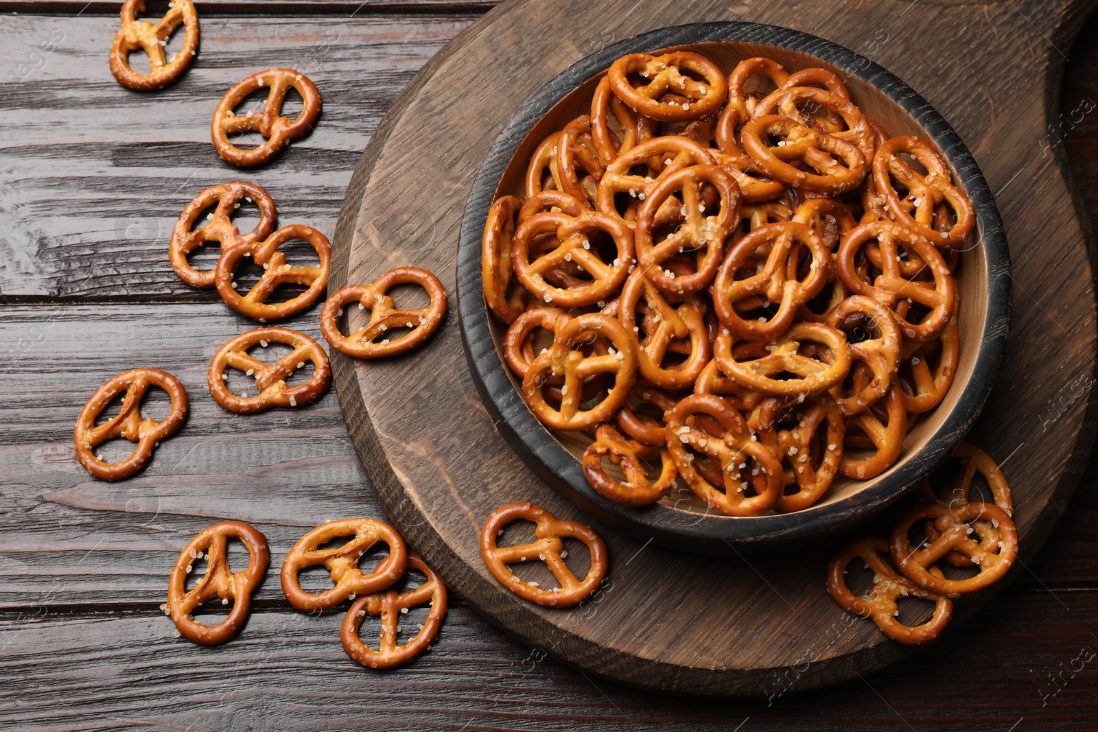 Photo of Tasty pretzel crackers on wooden table, top view