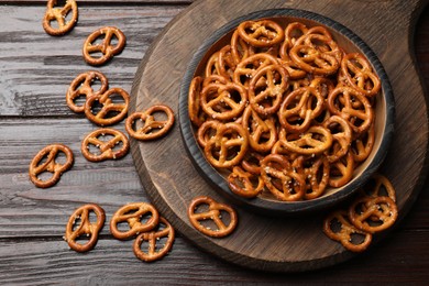 Photo of Tasty pretzel crackers on wooden table, top view