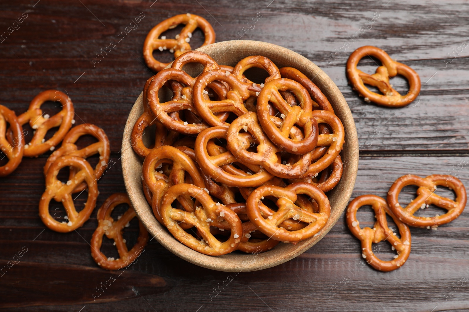 Photo of Tasty pretzel crackers on wooden table, top view