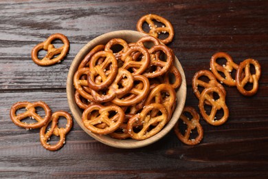 Photo of Tasty pretzel crackers on wooden table, top view