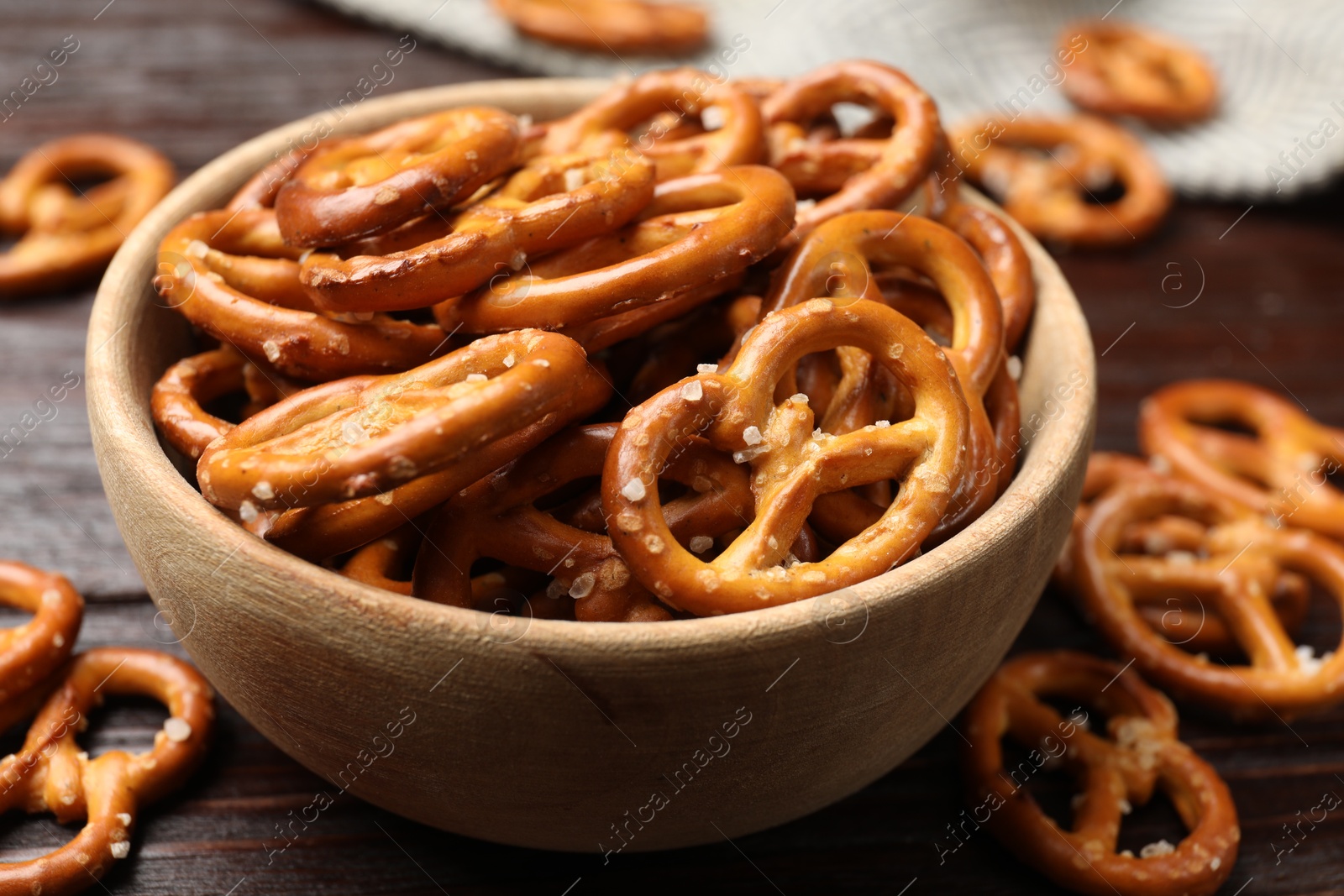 Photo of Tasty pretzel crackers on wooden table, closeup