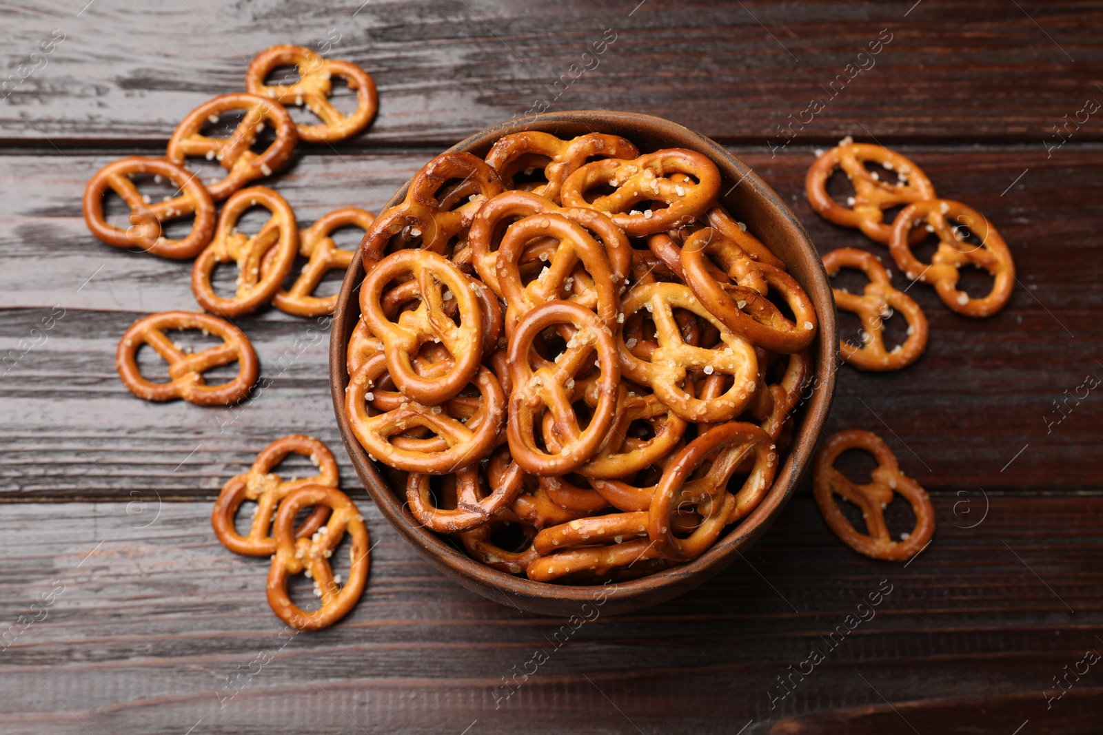 Photo of Tasty pretzel crackers on wooden table, top view